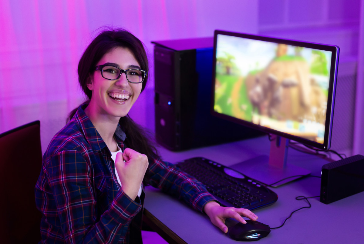 portrait of happy pro gamer girl looking at camera